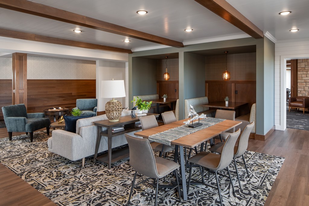 A modern dining room with a large table and chairs.