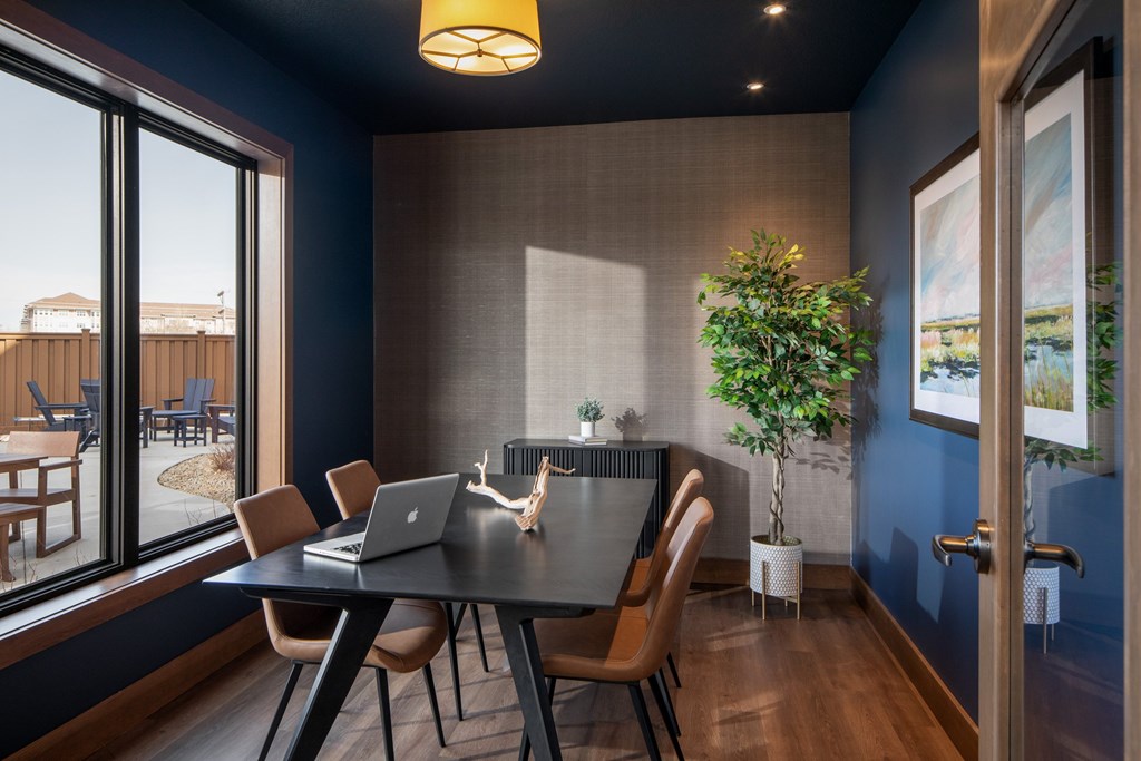 A modern dining room with a table set for four.