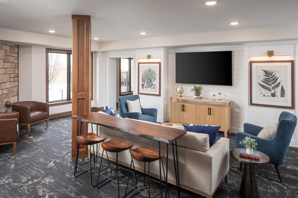 A living room with a long wooden table and a couch.