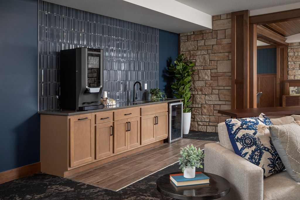 A modern living room with a stone wall and a wooden cabinet.