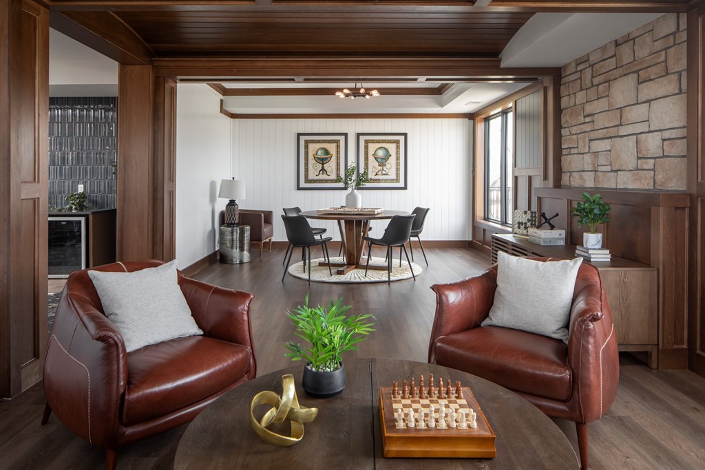 A living room with a chess board on the coffee table.