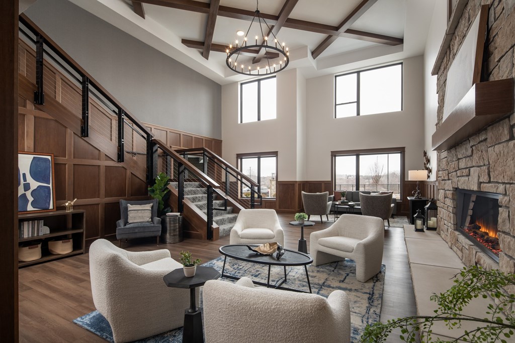 A living room with a fireplace and a staircase.
