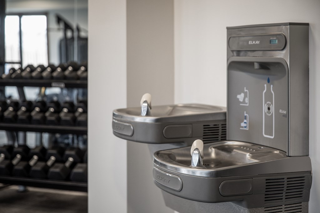 Two modern water fountains in a gym.