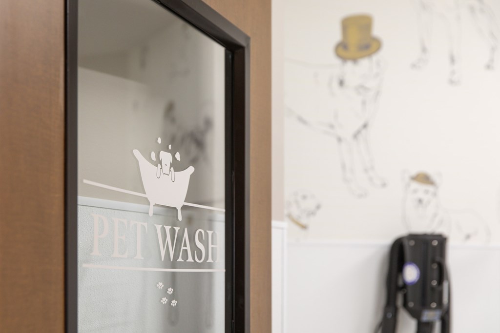A glass door with a sign that says pet wash.