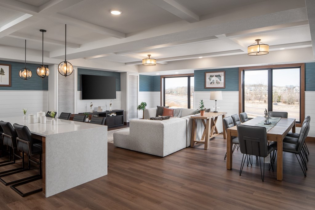 A modern open plan living and dining room with a kitchen area.