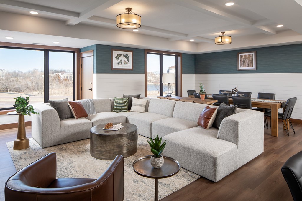 A living room with a large couch, a chair, and a coffee table.
