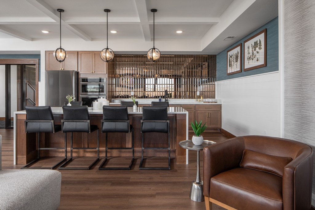 A modern kitchen with a bar area and seating.