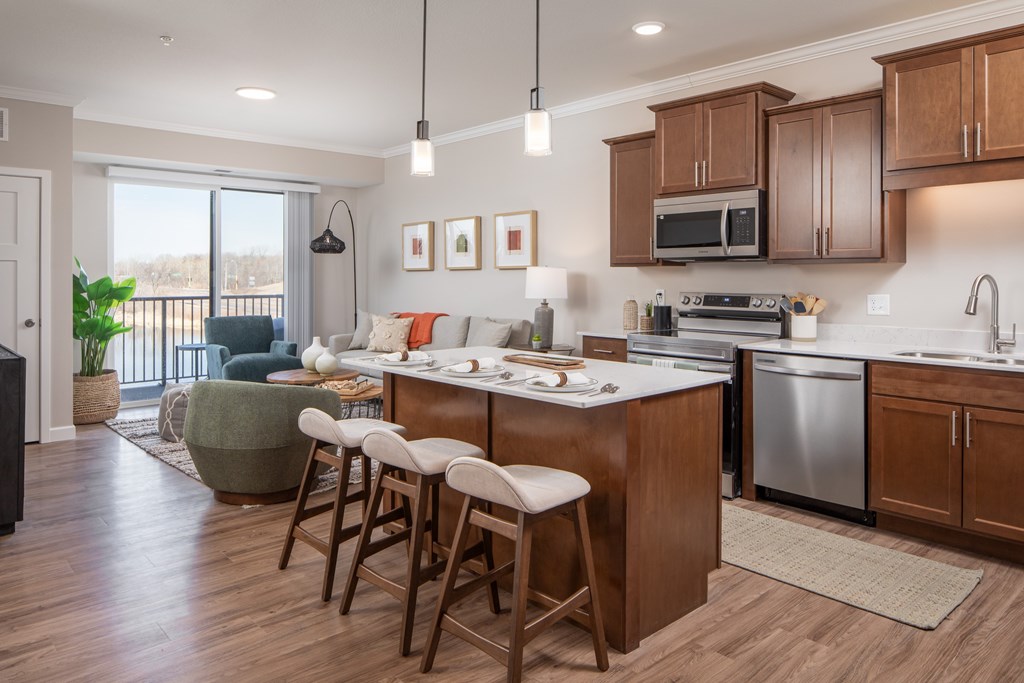 A kitchen with wooden cabinets and a dining table with chairs.