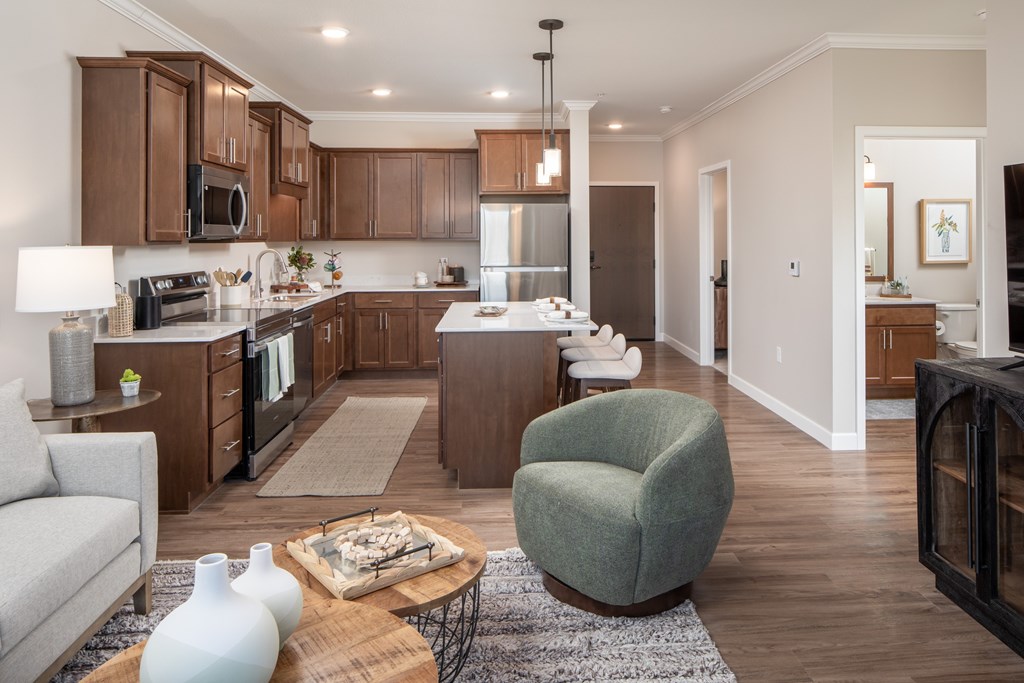 A modern kitchen with a grey armchair and a coffee table.