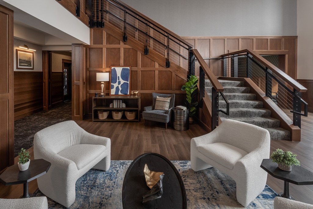 A living room with a staircase and a couch.
