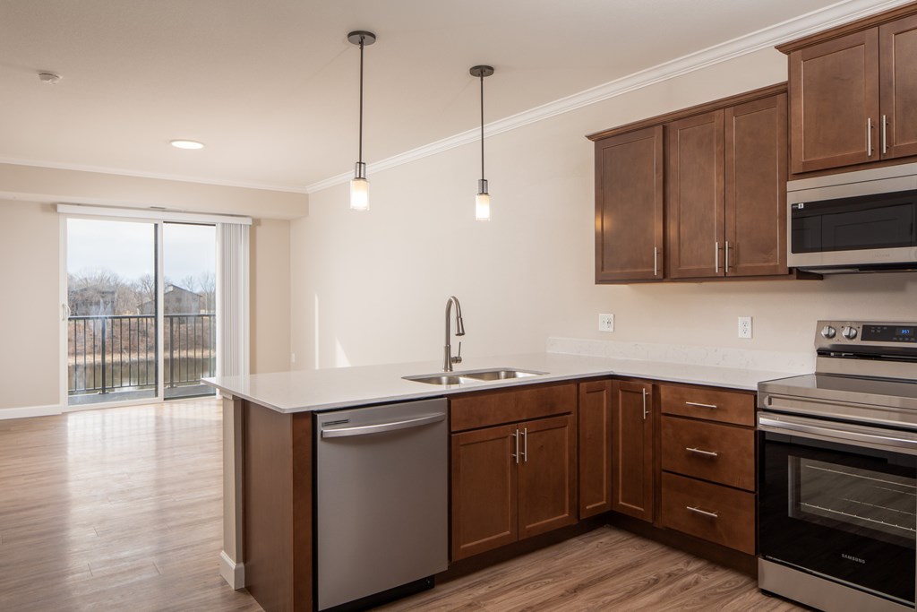 A kitchen with wooden cabinets and a white countertop.