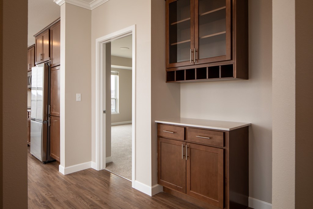 A kitchen with brown cabinets and a white door.
