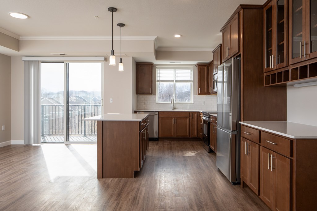 A modern kitchen with wooden cabinets and a large island.