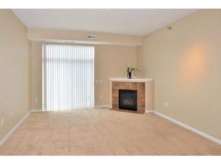a living room with a fireplace and a window