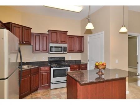 a kitchen with a center island and a stove top oven
