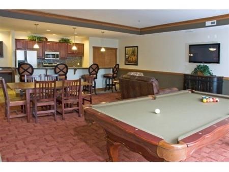 community room with a pool table and a television