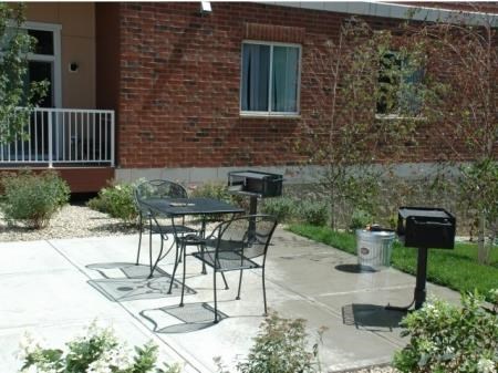 a patio with a table and chairs