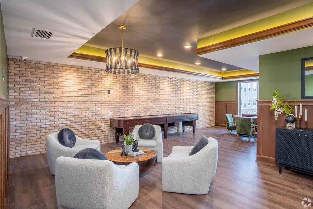 a living room with furniture and a pool table