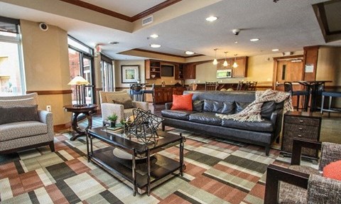 A living room with a black coffee table and a grey sofa.