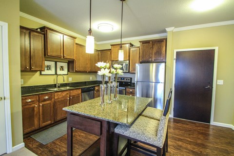 a kitchen with wooden cabinets and a granite counter top