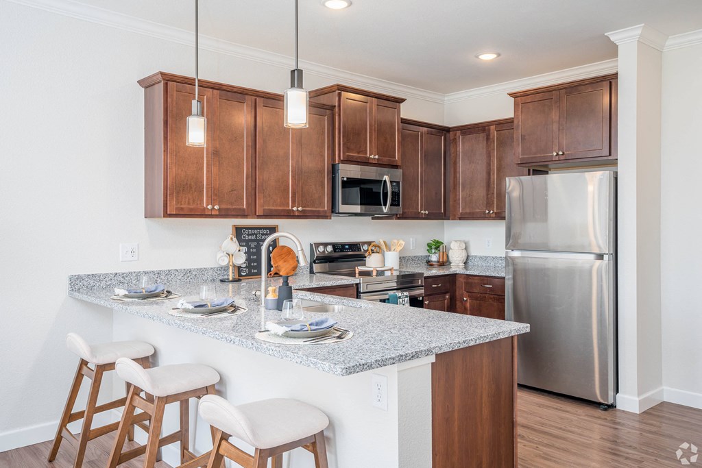 a kitchen with wood cabinets and stainless steel appliances