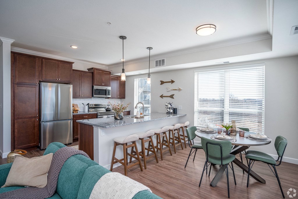 an open kitchen and dining area with a table and chairs