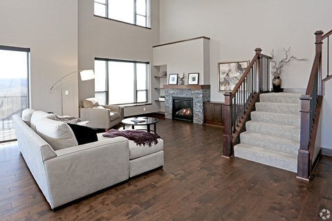 A living room with a white couch and a fireplace.