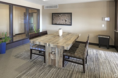 A dining room with a wooden table and chairs.