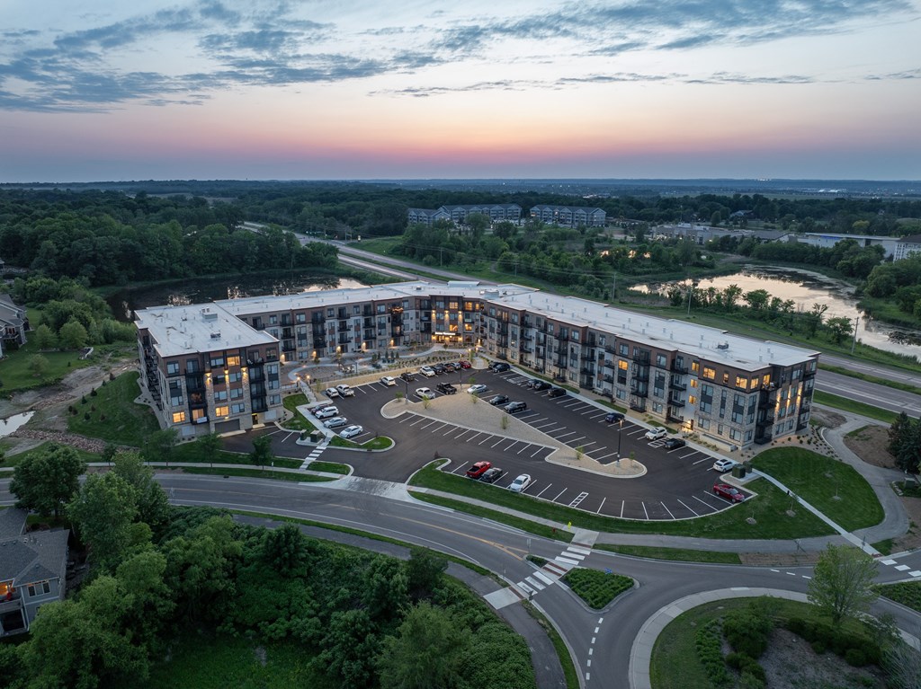 A large building with a parking lot in front of it.