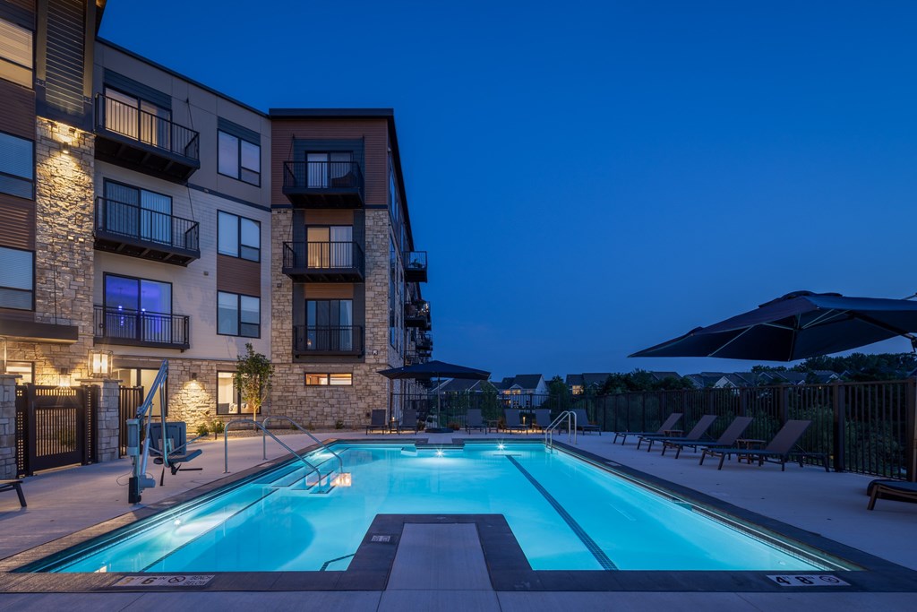 A swimming pool in front of a residential building.