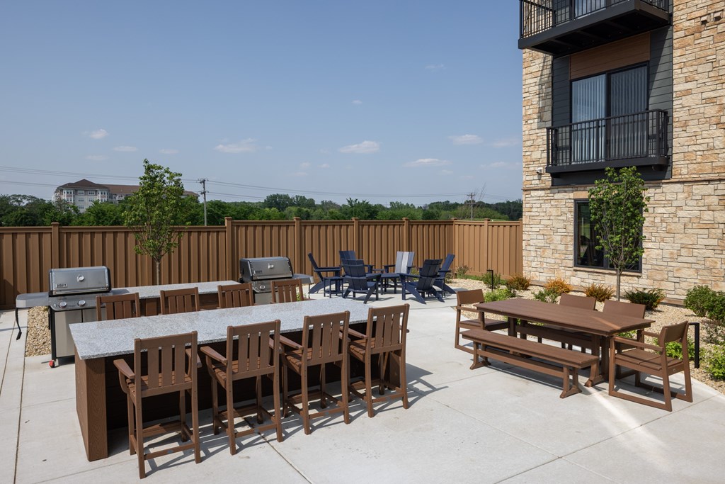 A patio with a table and chairs is set up outside a building.