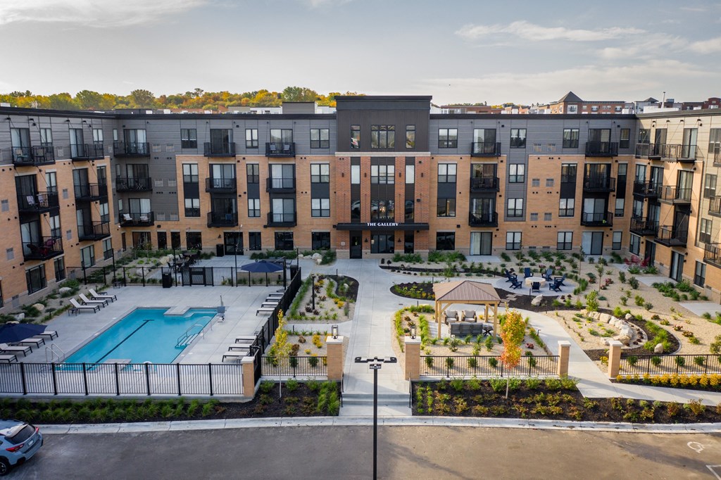 an aerial view of a large apartment complex with a swimming pool at The Gallery Apartments, Burnsville, Minnesota
