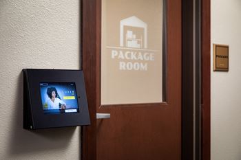 a door with a sign on it that says package roomat The Carver Apartments, Minnesota