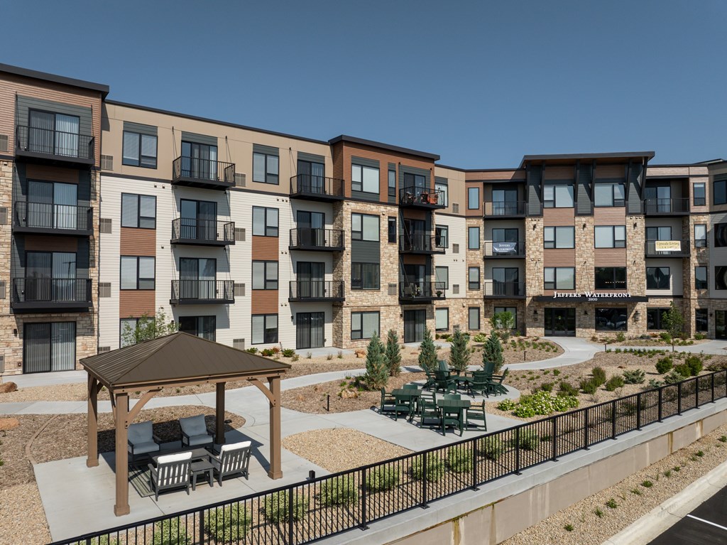 Apartment complex with a gazebo in the courtyard.