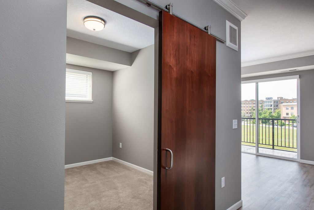 a bedroom with a sliding door  at Victoria Park and V2 Apartments, St. Paul