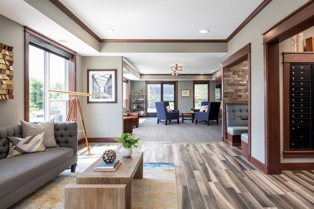 a common area filled with furniture and a large window  at Victoria Park and V2 Apartments, St. Paul