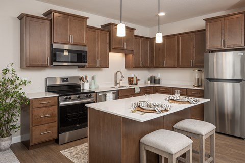 A kitchen with wooden cabinets and stainless steel appliances.