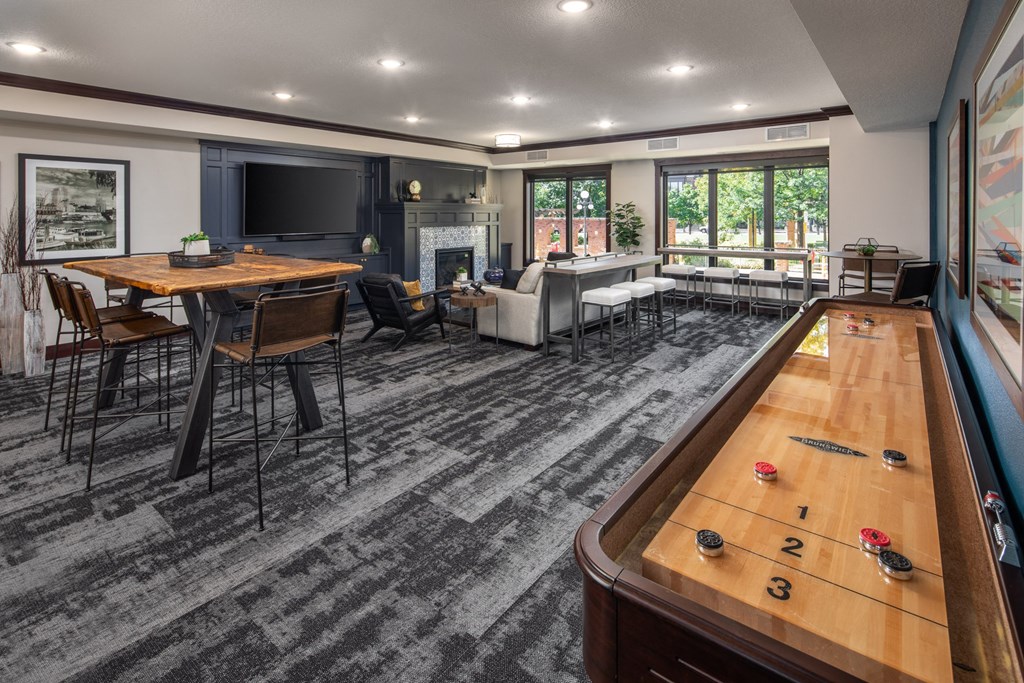 Indoor view of clubhouse equipped with game table and multiple seating areas  at The Whitley, St. Paul