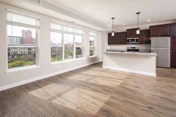 a kitchen and living room with a large windowat The Carver Apartments, Chaska, MN