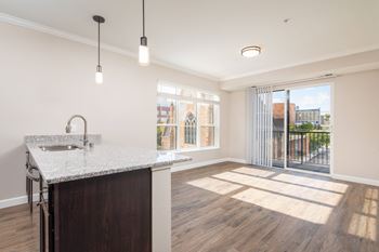 a kitchen and living room in a 555 waverly unitat The Carver Apartments, Chaska, MN