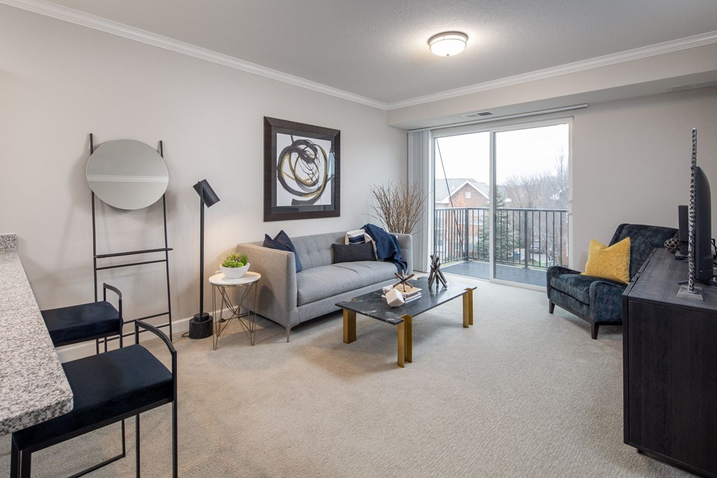 a living room with a couch and a chair at The Gallery Apartments, Burnsville, MN, 55337