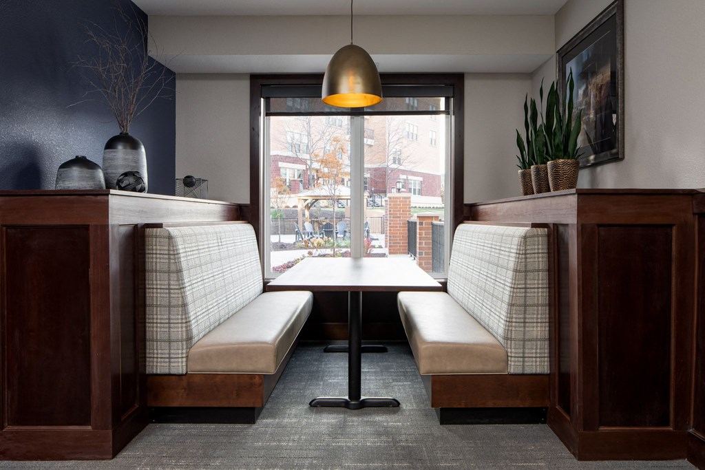 a sitting area booth in front of a window at The Gallery Apartments, Burnsville, MN, 55337