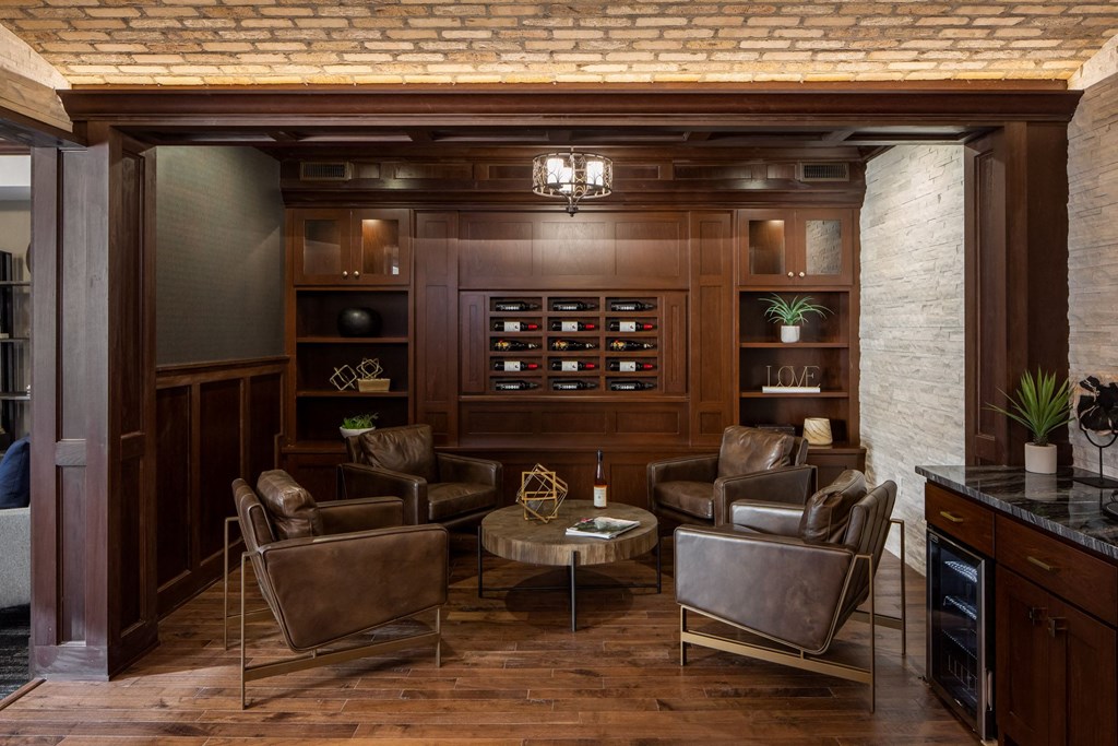 a room with furniture and a large wooden wall with artificial wine at The Gallery Apartments, Burnsville, Minnesota