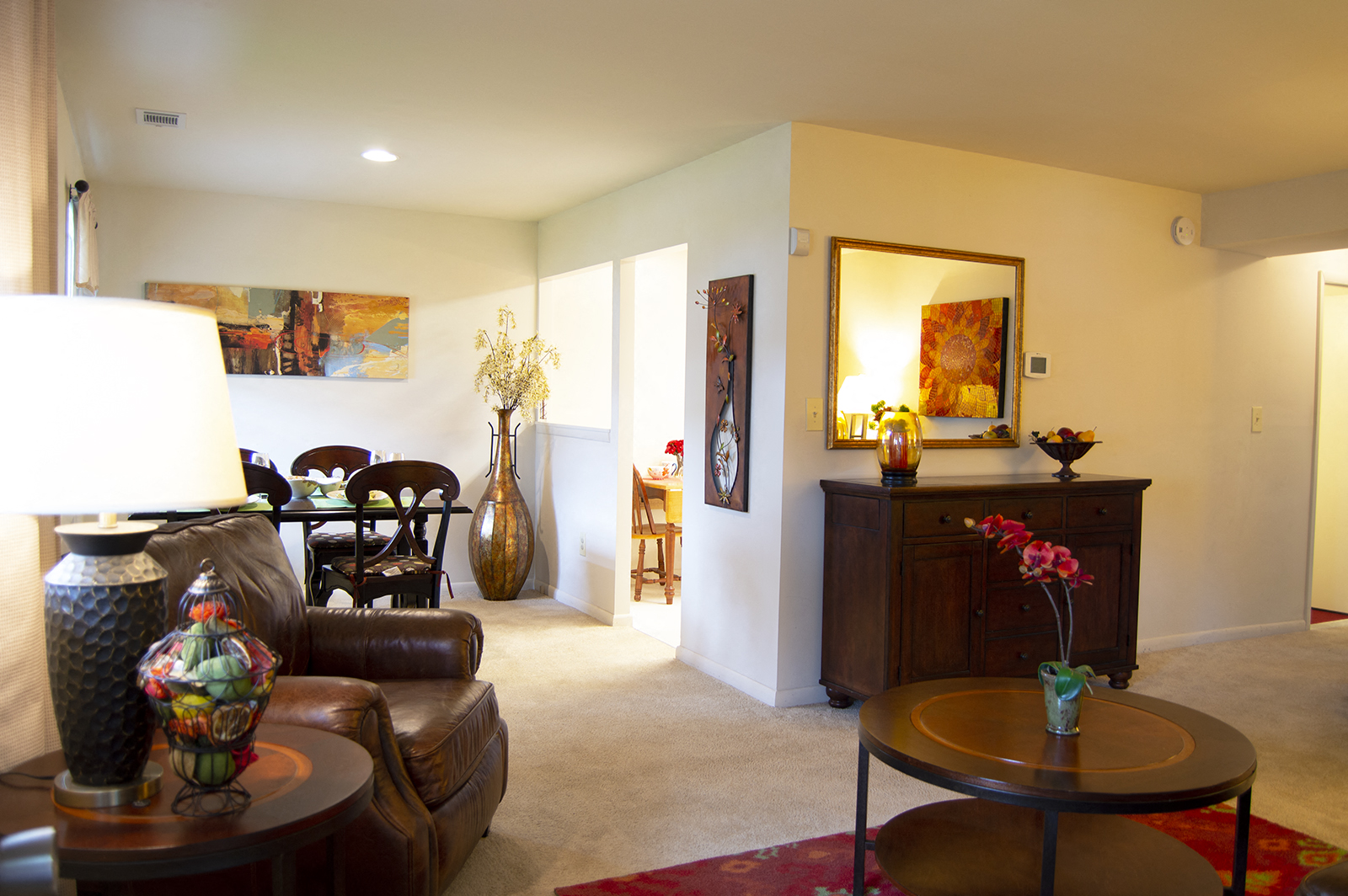 A living room with a brown leather couch and a wooden coffee table.