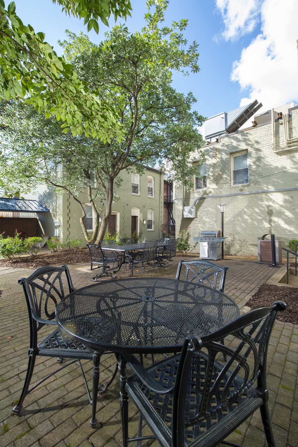 a patio with a table and chairs at Queen Anne Belvedere, Baltimore, MD 21201