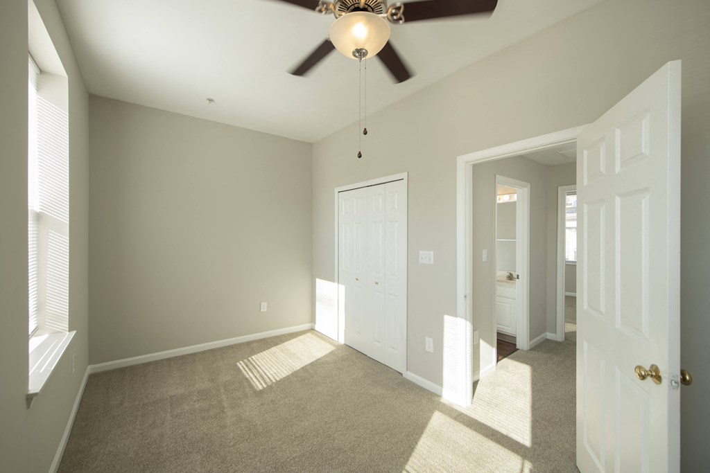 an empty living room with a ceiling fan at Queen Anne Belvedere, Baltimore, 21201