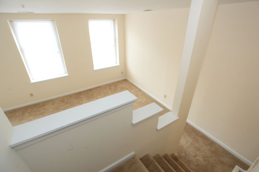 a view of a living room from the top of a staircase