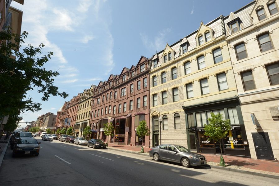 a city street filled with cars and tall buildings