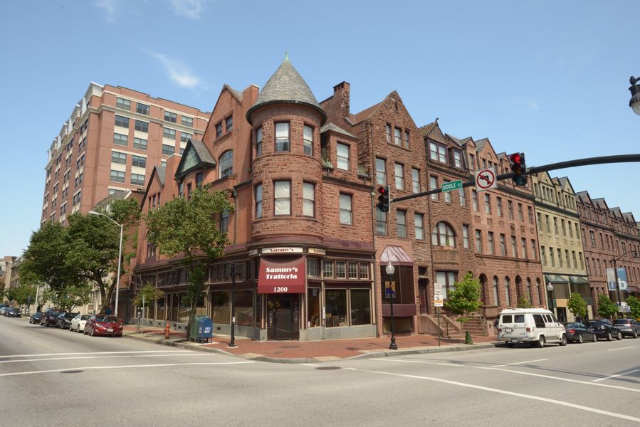 a large brick building on the corner of a city street