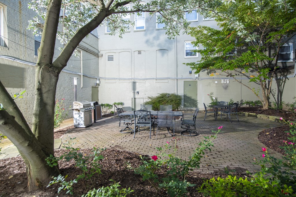a patio with tables and chairs in front of a building at Queen Anne Belvedere, Baltimore